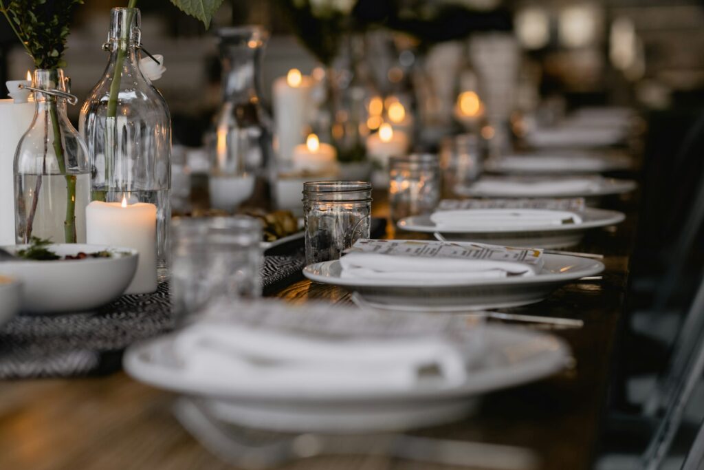 Home Long candlelit dinner table set for an event