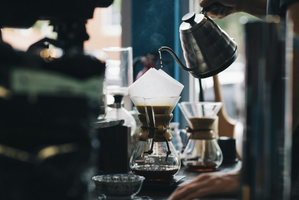 Home Barista brewing pour-over coffee with a gooseneck kettle